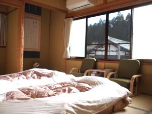 Postel nebo postele na pokoji v ubytování Guest House hachi hachi