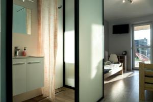 a kitchen with white cabinets and a mirror at Pensjonat Lubianka in Starachowice