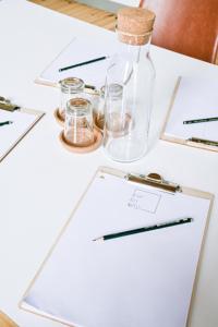 a white table with a bottle and glasses on it at berlincity in Berlin