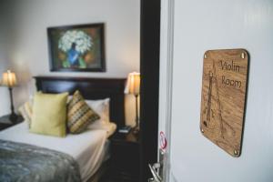 a hotel room with a bed and a sign on the door at The Symphony Guest House in Queenstown