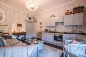 a living room with a couch and a kitchen at Church Apartment in Shrewsbury