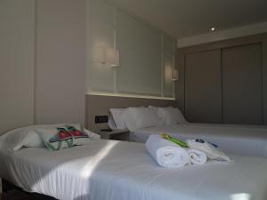 a hotel room with a bed and a desk at Oca Playa de Foz Hotel&Spa in Foz