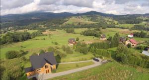 an aerial view of a house in a green field at Villa Dorka in Istebna