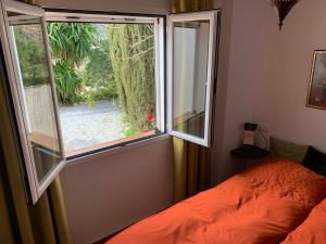 a bedroom with a window and a bed in it at Casandalusí in Frigiliana