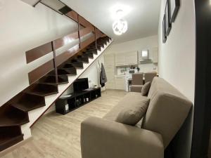 a living room with a couch and a staircase at The Place In Rome Guest House in Rome