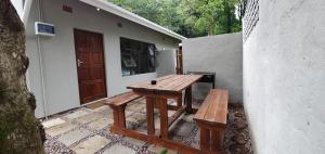 a wooden table and bench in front of a building at Dream Hills in Hillcrest