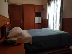 Ein Bett oder Betten in einem Zimmer der Unterkunft Hotel Ionion