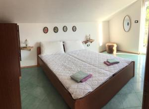 a bedroom with a bed with two towels on it at Lipovac resort Ficus in Bilice +75 photos