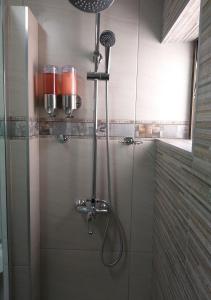 a shower with a shower head in a bathroom at Arrowood 2 in Plettenberg Bay
