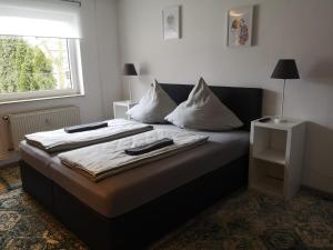 a bed with two pillows on it in a room at Jonas Apartment in Winterberg