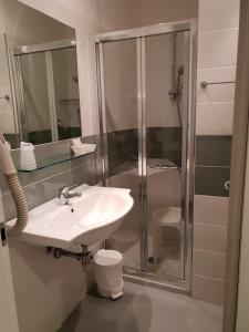 a bathroom with a sink and a shower at Hotel Ambasciata in Riccione