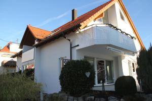 a white house with a balcony on it at Ferienwohnung Messe Stuttgart - Leinfelden-Echterdingen in Leinfelden-Echterdingen