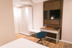 TV a/nebo společenská místnost v ubytování Arberia Palace Hotel