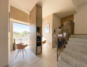 a hallway with a staircase and a table and chairs at Hostal12 in El Campello