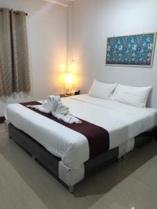 a bedroom with two beds with white sheets at Y&N House in Prachuap Khiri Khan