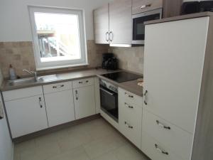 Kuchyň nebo kuchyňský kout v ubytování Ferienhaus Dat Fischerhus