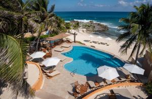 an aerial view of a resort with a swimming pool and the beach at Hotel Playa La Media Luna in Isla Mujeres