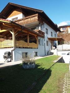 a house with a wooden roof and a yard at Casa Karin in Villach