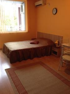 a bedroom with a bed and a window and a table at Marina Studio in Burgas City