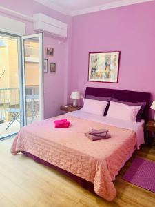 a bedroom with a large bed with purple walls at Bring only your toothbrush! in Athens