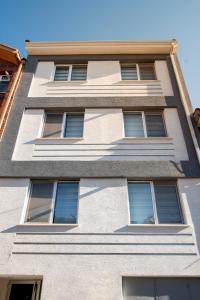 a tall white building with many windows at Arney Suites in Eskisehir