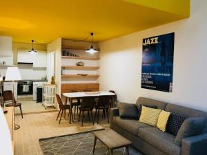 a living room with a couch and a table at Hôtel Villa Blomet in Paris +10 photos