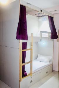 a bunk bed with a ladder in a room at Homestay Ac Dormitory in New Delhi