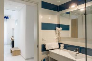a bathroom with a sink and a mirror at Gigli Hotel Salento in Marina di Pescoluse +213 photos