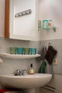 a bathroom with a sink and a cabinet with towels at les terrasses2 in Ostend