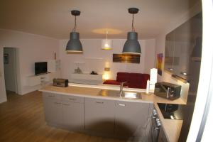 a kitchen with a sink and a living room at Ferienwohnung 6 Fam. Ramm in Sibbersdorf