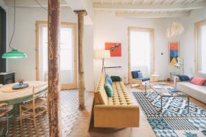a living room with a couch and a table at Hotel Hevresac Singular & Small in Mahón
