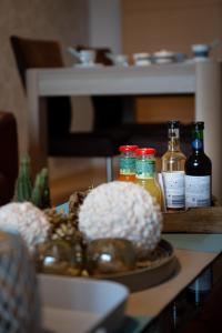 a table with a plate of food and bottles of sauce at les terrasses2 in Ostend
