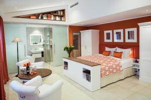 a bedroom with a bed and a living room at Passau - Suites in Passau