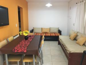a dining room with a table and a couch at El VIEJI in Colón