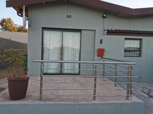 a metal railing in front of a house at Kom Kuier Self-Cater in Vredenburg