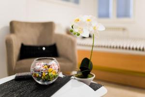 a small glass bowl with a flower on a table at Hostel Herz in Banja Luka