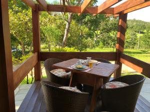 a wooden table and chairs on a wooden deck at Pousada Yvanna in Pirenópolis