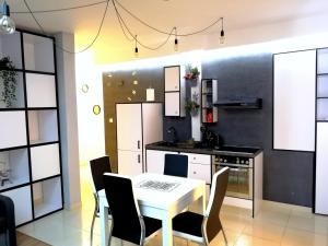 a kitchen with a table and chairs in a room at EASY RENT Apartments - LOFT, Centrum 24h Check-in in Lublin