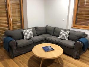 a living room with a couch and a table at Like Home Mountain in Bjelašnica