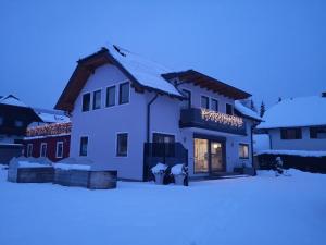 マリアプファルにあるFerienwohnung Laßhoferの雪に立つ二人の白い家