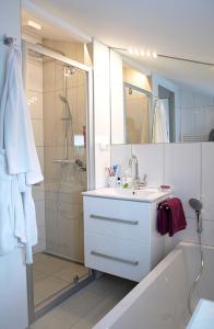 a white bathroom with a sink and a shower at Ferienhaus DANA in Meschede