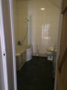 a bathroom with a tub and a toilet at Sycamore, Moss Hagg Farm in Selby