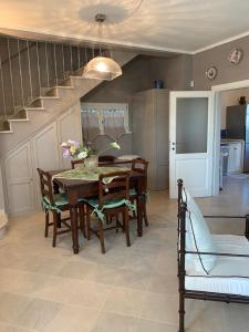 a dining room with a table and chairs and a staircase at Poderino della Lesca in Pietrasanta