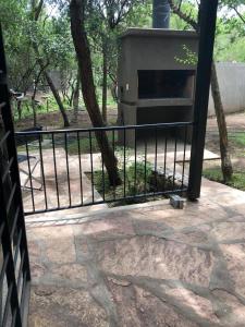 een grill op een patio naast een hek bij Cabañas Apart Margaridas in Merlo
