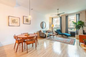 a living room with a table and chairs at Gorgeous Park House w Parking on Queen West in Toronto