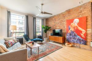 a living room with a brick wall at Gorgeous Park House w Parking on Queen West in Toronto