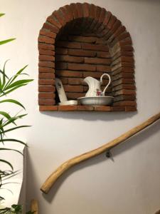 um forno de tijolo com um conjunto de chá na parede em Bike Pension Knausz em Pöls