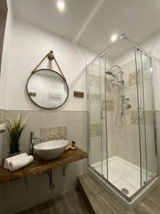 a bathroom with a shower and a sink and a mirror at La Corte Segreta Tivoli in Tivoli