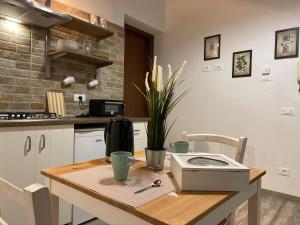 a kitchen with a wooden table with a counter top at La Corte Segreta Tivoli in Tivoli