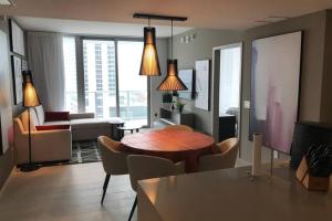 a living room with a table and chairs and a couch at Hollywood Beach luxury condo-HBH in Hollywood